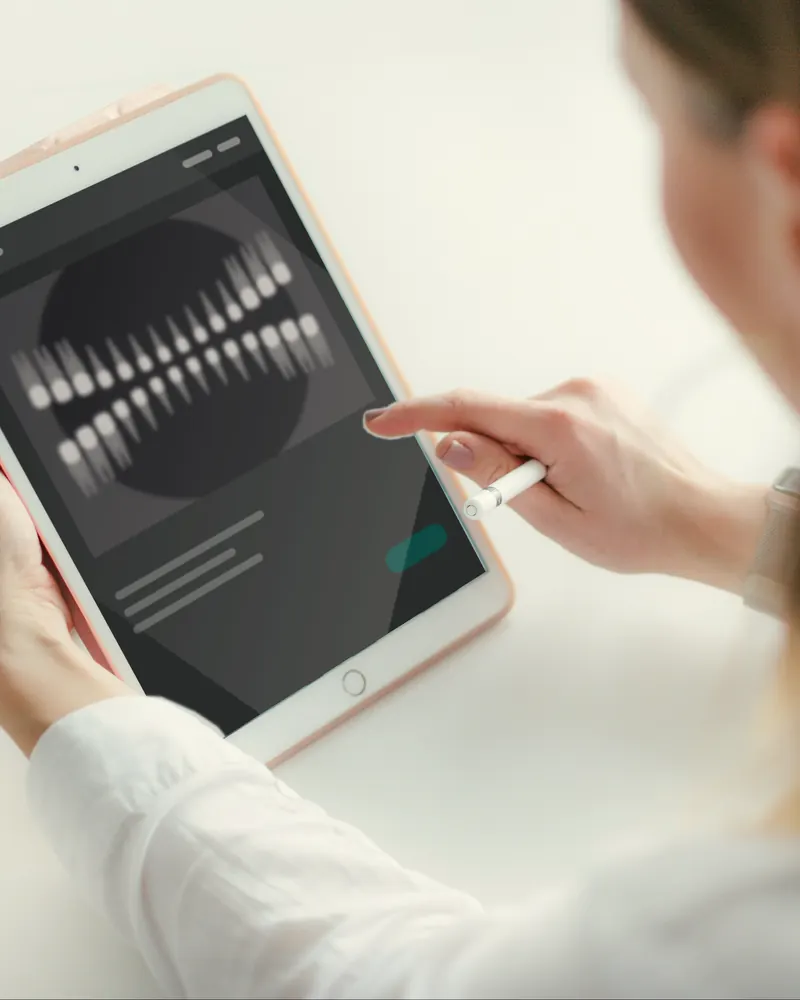 Dr. Rithika reading an X-ray on a tablet.