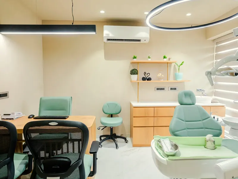 The consulting room, the dentist's desk beside the teal chair.