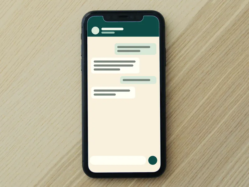A phone on the reception counter showing a chat.