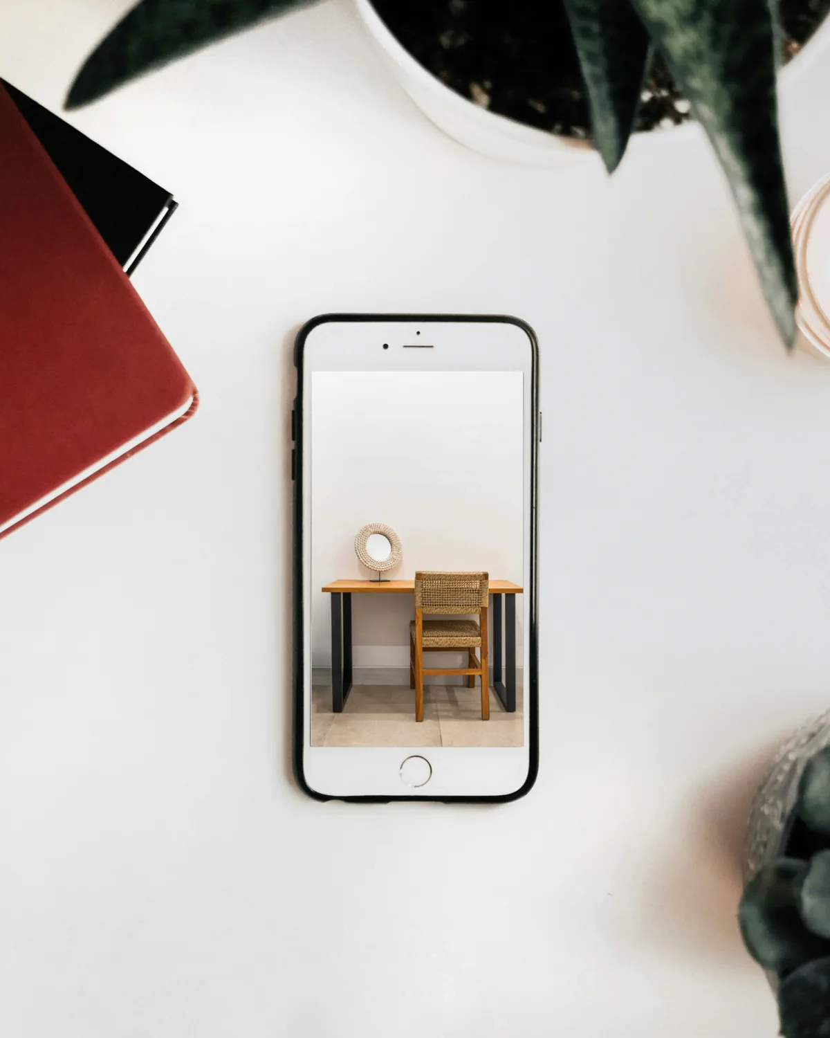 A phone on a table showing a photograph of a room.