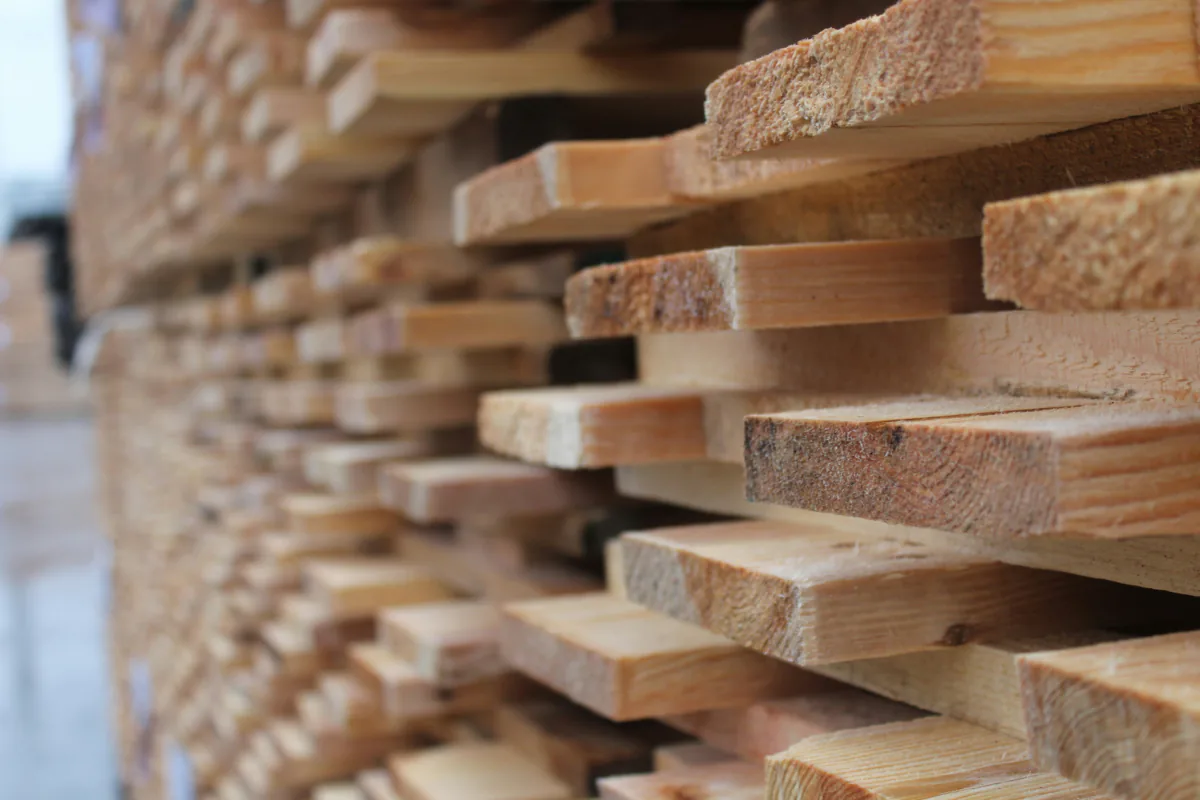 Planks stacked with spacers between them to season.