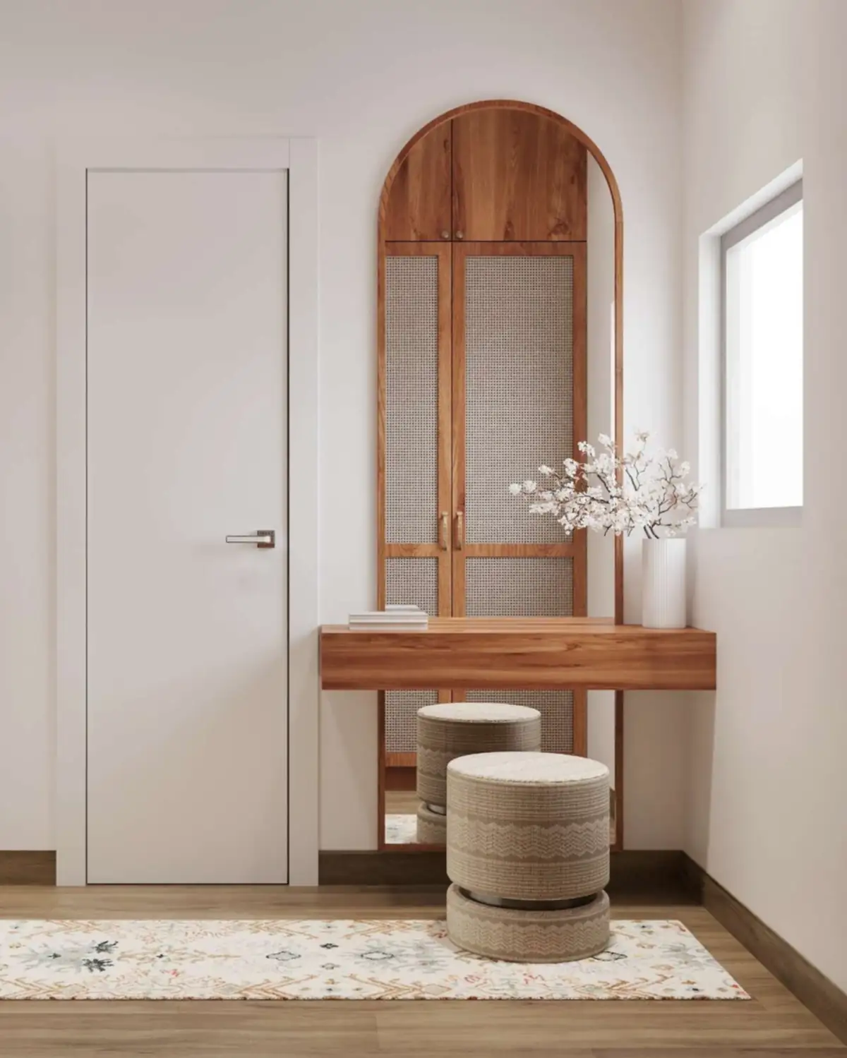 A wall-hung teak dressing shelf under a tall arched cabinet with a cane door, two round stools below.