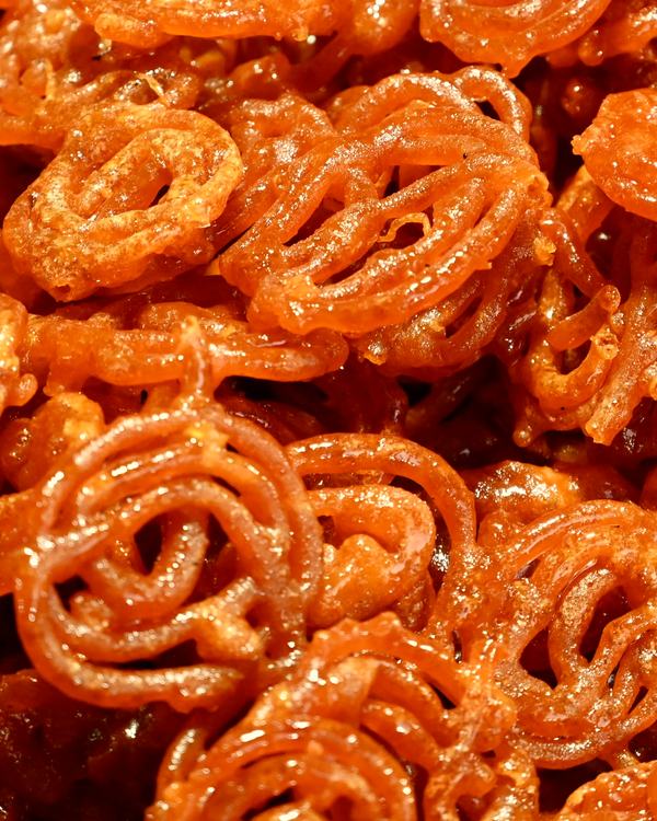 A heap of jilebi, the coils glossy with syrup.