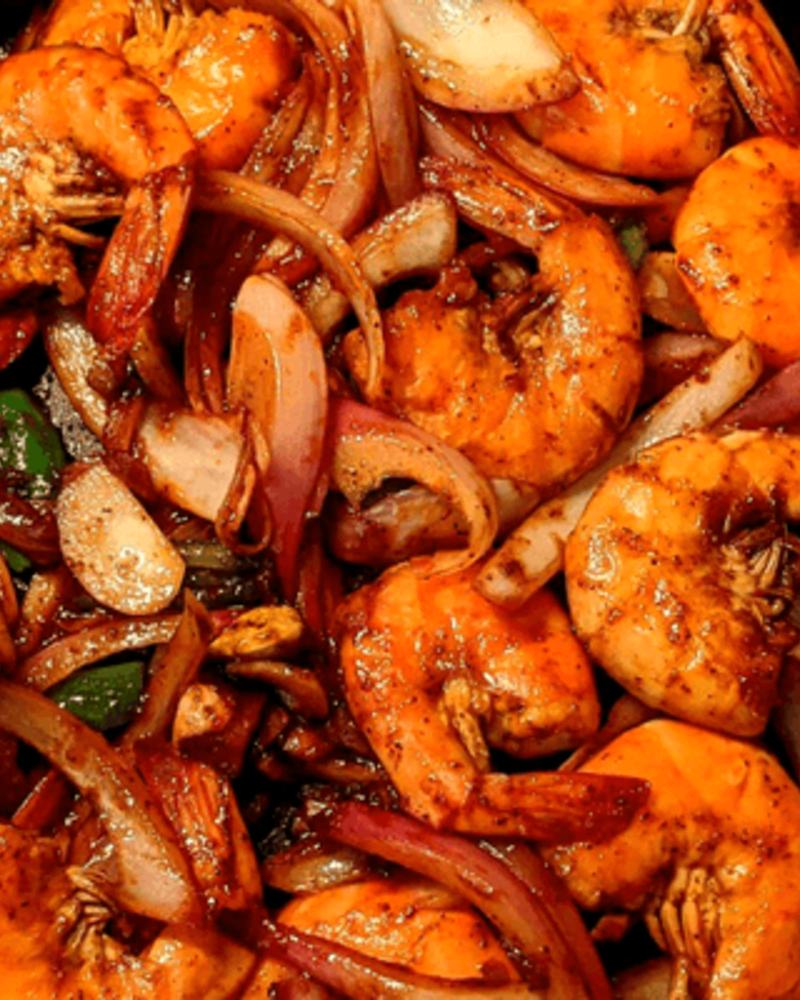 Royyala vepudu in the pan, the prawns and onion dark with pepper.